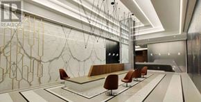 Toronto (Waterfront Communities) condo for rent - A modern office lobby with a marble wall and wooden chairs.
