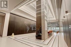 Toronto (Waterfront Communities) condo for rent - A hallway with a world map on the wall and a row of chairs on the right side.
