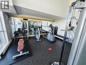 Coquitlam apartment for rent - A gym with a variety of equipment including a leg press machine, a treadmill, and a weight bench.