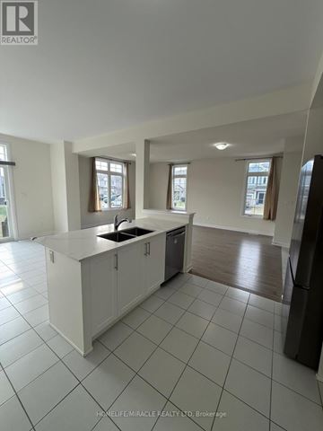 Loyalist (Bath) apartment for rent - A kitchen with white cabinets and a black fridge.