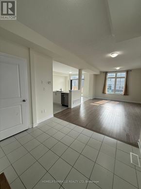 Loyalist (Bath) apartment for rent - A spacious living room with white tiled flooring and a large window.