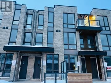 Toronto (Englemount-Lawrence) townhouse for rent - A modern building with a balcony on the second floor from the left.