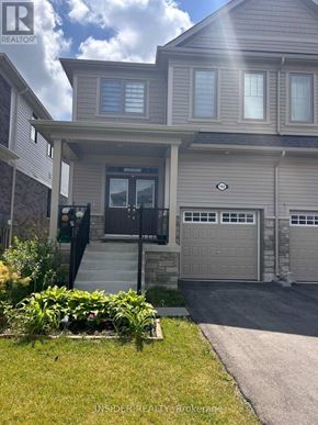 Centre Wellington (Fergus) apartment for rent - A house with a grey garage door and a black door.