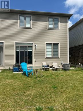 Centre Wellington (Fergus) apartment for rent - A house with a lawn and patio furniture in front.