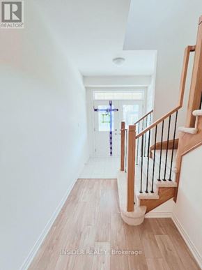 Centre Wellington (Fergus) apartment for rent - A wooden staircase with a white handrail and a window in the background.