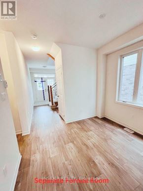 Centre Wellington (Fergus) apartment for rent - A long hallway with wood floors and white walls.