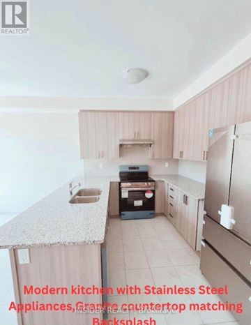 Centre Wellington (Fergus) apartment for rent - A modern kitchen with stainless steel appliances and granite countertop matching backsplash.