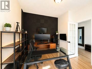 Ottawa apartment for rent - A modern living room with a glass table and a television.