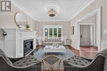 Toronto (Kingsway South) apartment for rent - A living room with a grey sofa and a white fireplace.