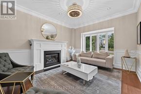 Toronto (Kingsway South) apartment for rent - A living room with a fireplace and a grey sofa.
