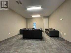 Waterloo condo for rent - A spacious room with a grey carpet and two black sofas.