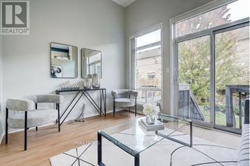 Mississauga (Central Erin Mills) townhouse for rent - A living room with a glass table and chairs.