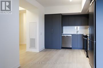 Toronto (Clanton Park) condo for rent - A kitchen with dark blue cabinets and stainless steel appliances.