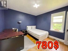 Hamilton (Ainslie Wood) apartment for rent - A bedroom with a bed, desk, and window is on sale for 780 dollars.