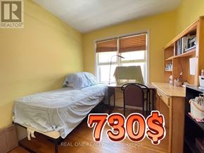 Hamilton (Ainslie Wood) apartment for rent - A bedroom with a bed, chair, and desk is on sale for 730$.