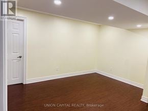 Oshawa (Taunton) apartment for rent - A room with a white door and wooden floor.