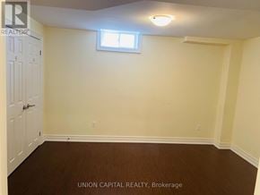 Oshawa (Taunton) apartment for rent - A room with a white door and a window with a white frame.