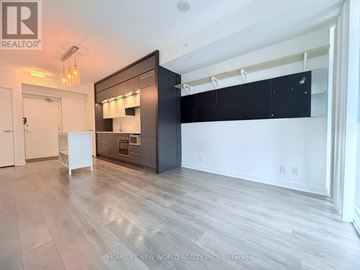 Toronto (Bay Street Corridor) condo for rent - A spacious kitchen with a black cabinet and white appliances.