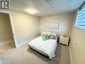 London North (North G) apartment for rent - A bedroom with a bed, nightstand, and a framed picture on the wall.