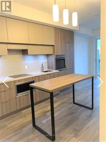 Toronto (Mount Pleasant West) condo for rent - A kitchen with a table and a microwave oven.