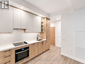 Vaughan (Vaughan Corporate Centre) condo for rent - A modern kitchen with wooden cabinets and a stainless steel sink.