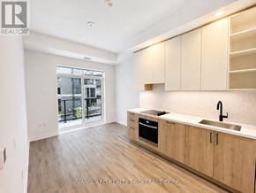 Vaughan (Vaughan Corporate Centre) condo for rent - A kitchen with wooden cabinets and a sink.