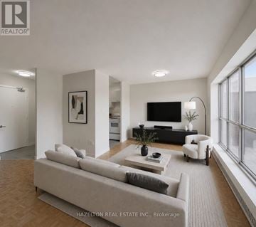 Toronto (Mount Olive-Silverstone-Jamestown) condo for rent - A modern living room with a large couch and a flat screen TV.
