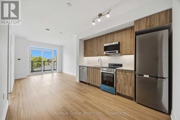 Toronto (Bathurst Manor) condo for rent - A modern kitchen with wooden cabinets and stainless steel appliances.