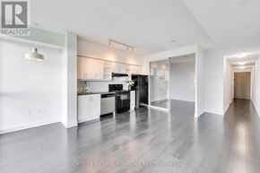 Toronto (Thorncliffe Park) condo for rent - A spacious kitchen with white cabinets and black appliances.