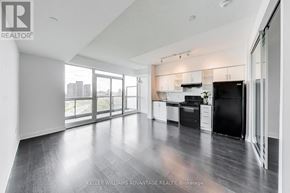 Toronto (Thorncliffe Park) condo for rent - A spacious kitchen with black appliances and wooden floors.