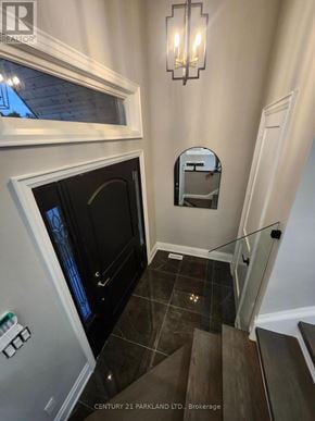 Oro-Medonte apartment for rent - A staircase with a glass railing and a mirror on the wall.