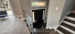Oro-Medonte apartment for rent - A staircase with a glass railing and wooden steps.