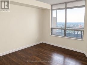 Toronto (West Humber-Clairville) condo for rent - A room with a large window and wooden flooring.