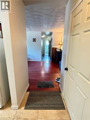 Waterloo apartment for rent - A hallway with a rug on the floor leading to a door.