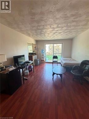 Waterloo apartment for rent - A room with a wooden floor and a ceiling with a textured finish.