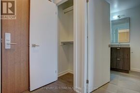 Toronto (Henry Farm) condo for rent - A white door is open to a room with a wooden floor and a brown wardrobe.