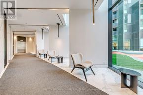 Toronto (Clanton Park) condo for rent - A hallway with a carpeted floor, white walls, and a row of chairs.