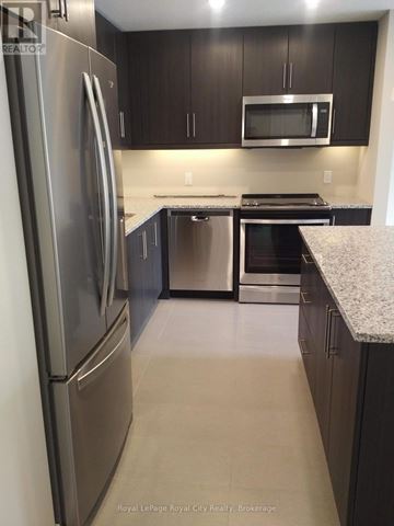 Guelph (Clairfields/Hanlon Business Park) townhouse for rent - A kitchen with a refrigerator, microwave, oven and dishwasher.