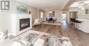 Oshawa (O'neill) apartment for rent - A living room with a fireplace and a rug in the middle.