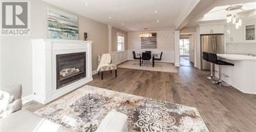 Oshawa (O'neill) apartment for rent - A living room with a fireplace and a rug in the middle.