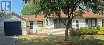 Sarnia apartment for rent - A house with a tree in front of it.