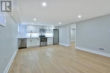 Oakville (Co Central) apartment for rent - A well-lit, spacious kitchen with white cabinets and stainless steel appliances.