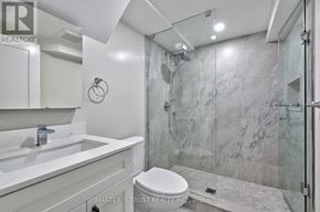 Oakville (Co Central) apartment for rent - A bathroom with a marble wall and a toilet.