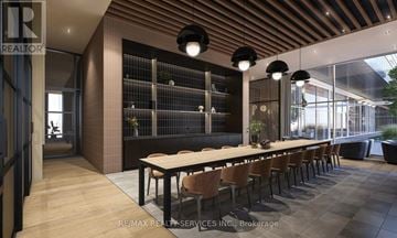 Brampton (Bram East) condo for rent - A modern dining room with a long table and chairs.