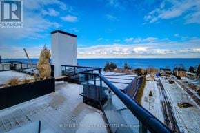 Hamilton (Lakeshore) condo for rent - A balcony overlooks a snowy landscape with a clear blue sky.