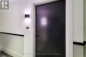 Hamilton (Lakeshore) condo for rent - A door with the number 213 on the wall above it.