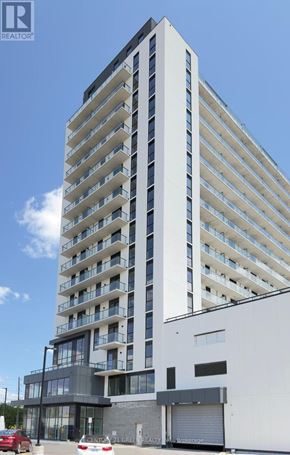 Brantford condo for rent - A tall white building with balconies on the upper floors.
