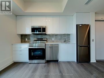 Brantford condo for rent - A modern kitchen with white cabinets and stainless steel appliances.