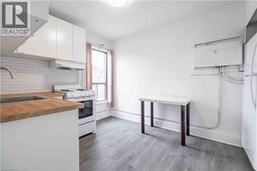 Hamilton apartment for rent - A kitchen with a white counter and a wooden island.