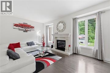 Niagara Falls apartment for rent - A living room with a white couch and a fireplace.